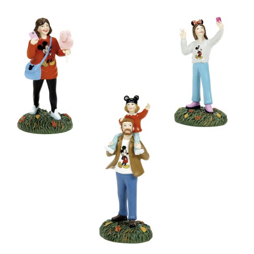 family visiting disney park figurines