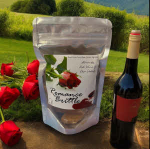 Romance Brittle bag in field with red wine bottle and roses