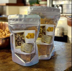 Peanut Brittle bags on counter with peanuts