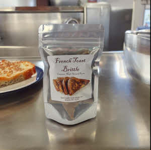 French Toast Brittle bag on stainless steel counter with french toast on a plate