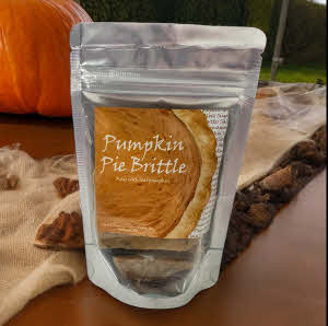 pumpkin pie brittle bag on counter with pumpkin in the background